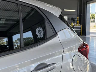Selo de garantia aplicado no vidro de um carro com película